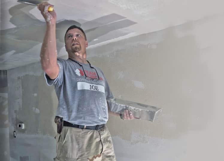 Joe Glanton, a GAF employee, volunteering to help build a home