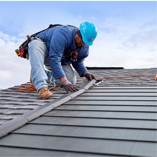 GAF Energy employee installing solar shingles