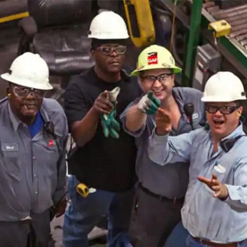 Four excited GAF employees in plant 
