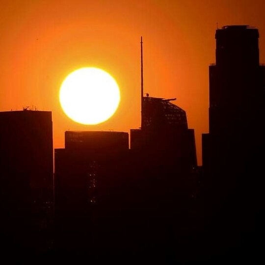 Sun setting during city skyscrapers