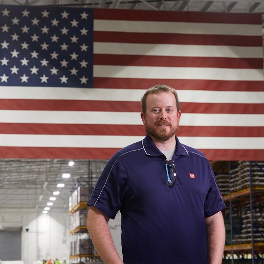 GAF employee smiling inside a factory