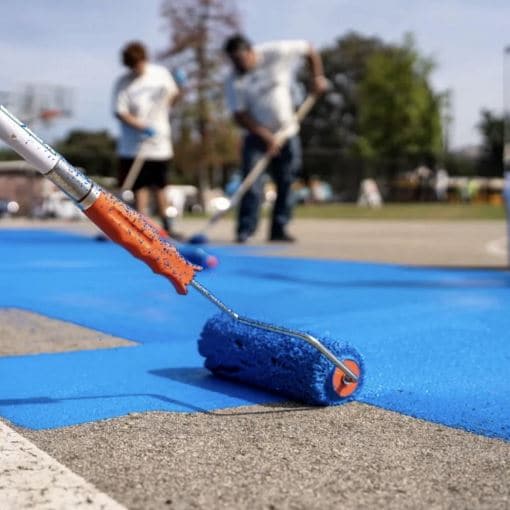 GAF Cool Community Project members painting blue StreetBond coating on Los Angeles city streets.
