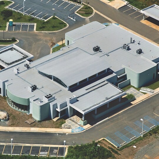 Aerial view of a large, modern, building with a Modified Bitumen Roof.