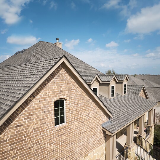 GAF UHDZ shingle roof installation on a large brick home.
