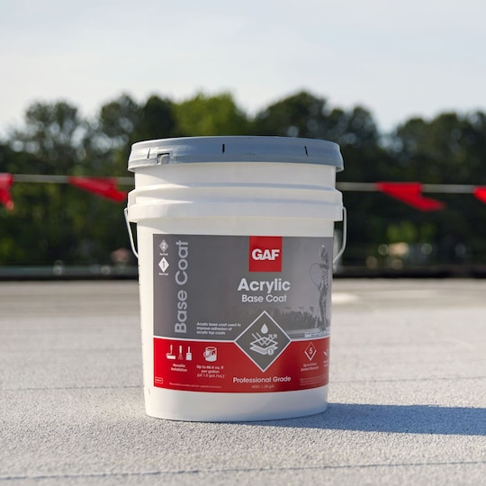 A container of GAF Acrylic Top Coat on a flat roof