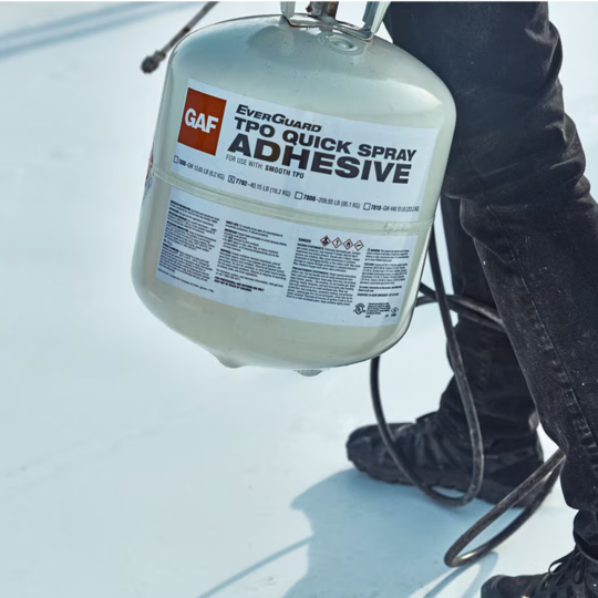 A GAF certified contractor carrying a portable canister of GAF EverGuard TPO QuickSpray Adhesive.