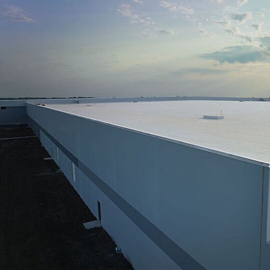  An aerial shot of a large commercial building with a flat roof.