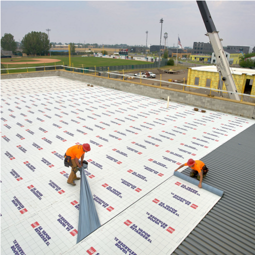 Roofing contractors installing commercial roofing underlayment