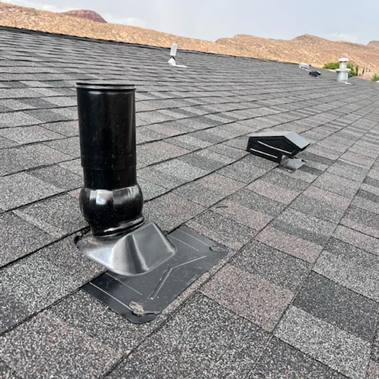 Rooftop view of a house with GAF shingles and accessories installed.