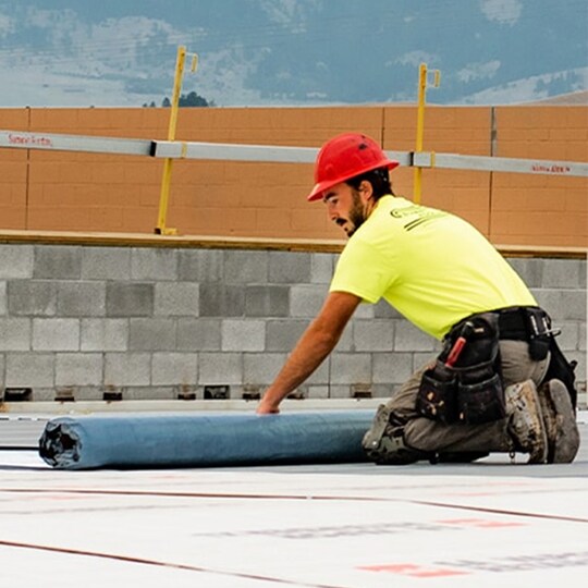 GAF certified contractors rolling out the new roof of Bozeman Public Safety Center in Montana
