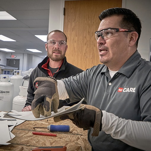 Latino roofers taking roofing classes in Spanish with GAF CARE