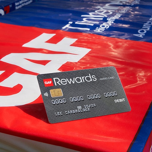 GAF rewards card for roofing contractors on top of Timberline shingles.