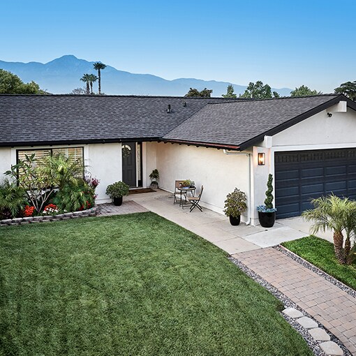A white house with a gray roof built with Timberline HDZ RS shingles