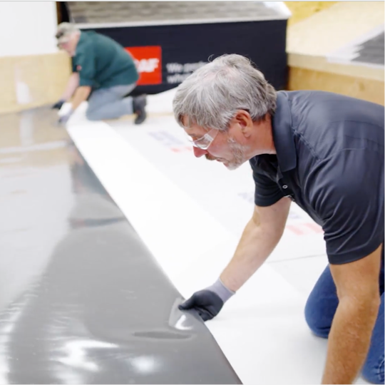 Dave Scott and Wally Brown demonstrating how to install a TPO membrane. 