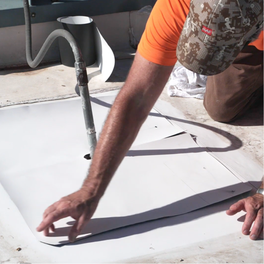 A GAF certified contractor repairing an improperly installed, leaking pitch pocket detail on a TPO commercial roof.