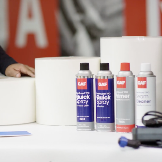 Display of GAF roof repair and maintenance spray cans, cleaners, and sealants for TPO and PVC systems.