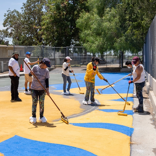 GAF roofing volunteers applying cooling coating in LA neighborhoods