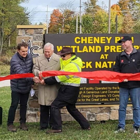 Employees at ribbon cutting for new wetland preserve donated by GAF