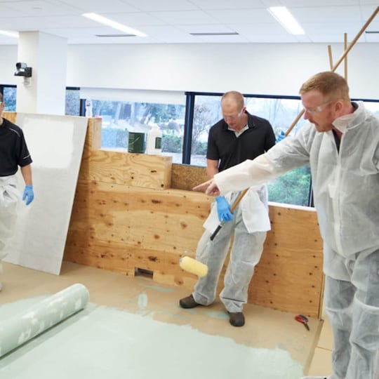 Inmates learning valuable roofing skills from GAF roofing academy.