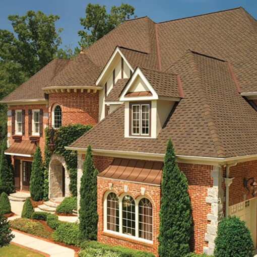 Red brick house with brown impact resistant shingles