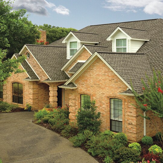 Rooftop view of a house with GAF shingles and accessories installed.