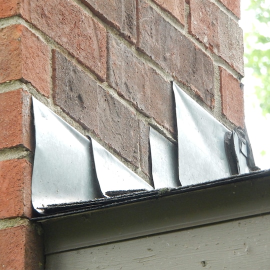 Damaged flashing on a roof letting in moisture. 