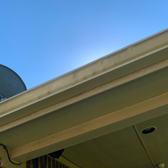 Roof damage from hail on gray roof shingles.