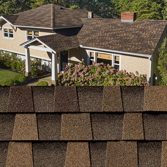 GAF Timberline HDZ® Chestnut Valley Shingle closeup with sample product image on a beige house.