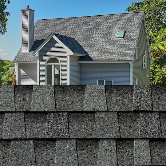 GAF Timberline HDZ® Cliffside Shingle closeup with sample product image on a light blue house.