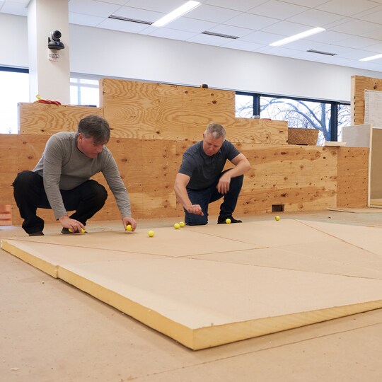 Two men working with GAF tapered insulation