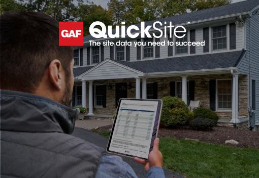Contractor holding tablet in front of home open to QuickSite property data reports from GAF
