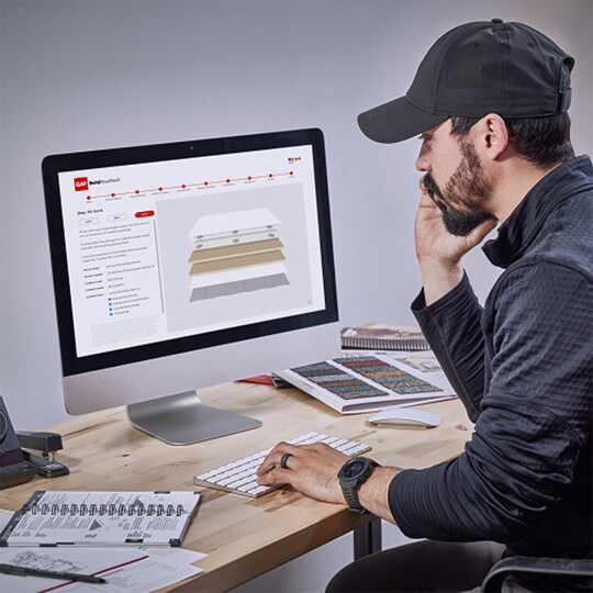 A man working on a roof assembly using the BuildYourRoof tool.