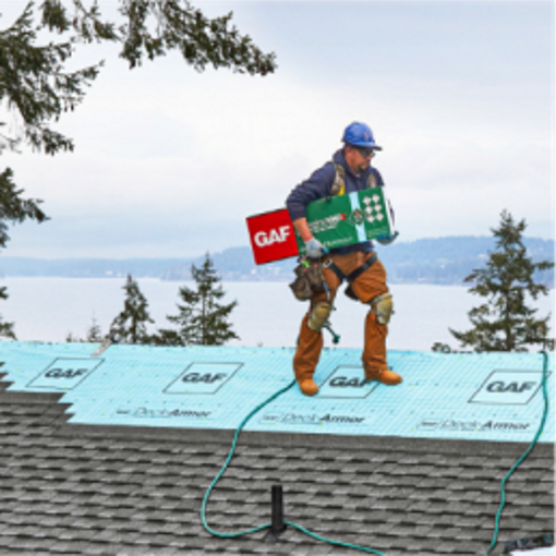 Residential roofing contractors adding components of GAF lifetime roofing system warranty on a roof