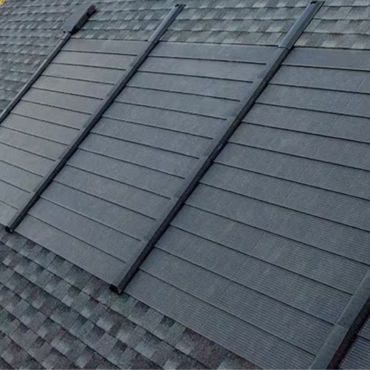 A side view of a house roof featuring solar panels installed as part of GAF’s Timberline Solar roof system
