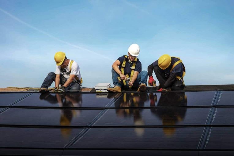 Contractors installing GAF Energy solar shingles