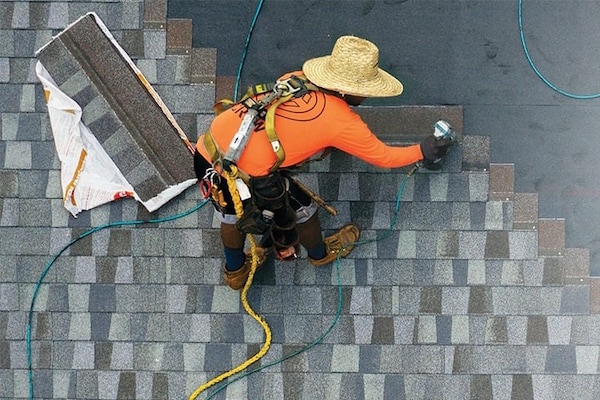 Roofing contractor nailing GAF roof shingles