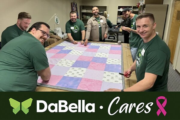Several members of the DaBella team volunteering at a charitable event for breast cancer