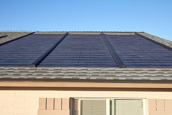  Shingled residential roof with GAF Timberline Solar energy shingles installed on one side