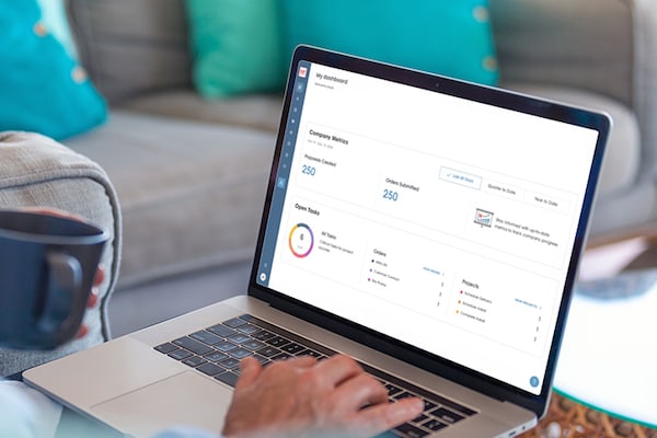 A contractor accessing the  GAF Energy Partner Portal on a laptop. 