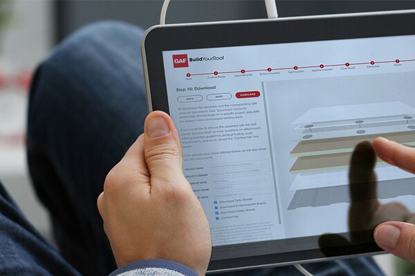Roofing professional using GAF commercial roofing system design tool on a tablet