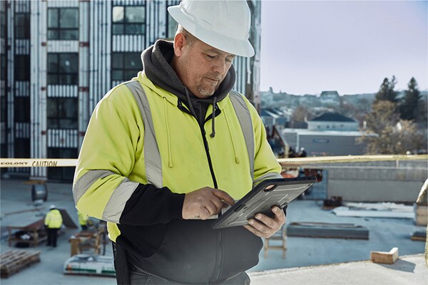 Commercial contractor looking down at ipad to view the Maintenance Checklist