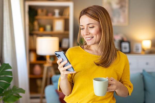 A woman viewing the GAF Energy Services portal on her mobile phone
