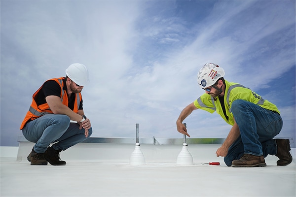 Property owner on building inspecting the roof
