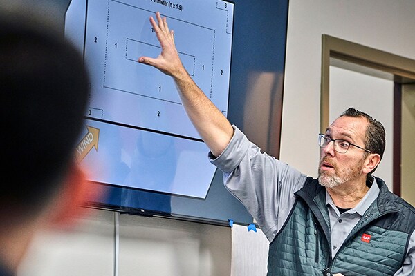 Roofing professional from GAF CARE Contractor training center showing diagram on screen