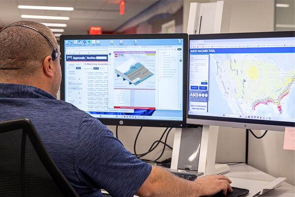 A GAF Design Services team member preparing assembly letters for a project