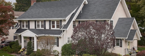 beauty shot of a white home with gray GAF roof