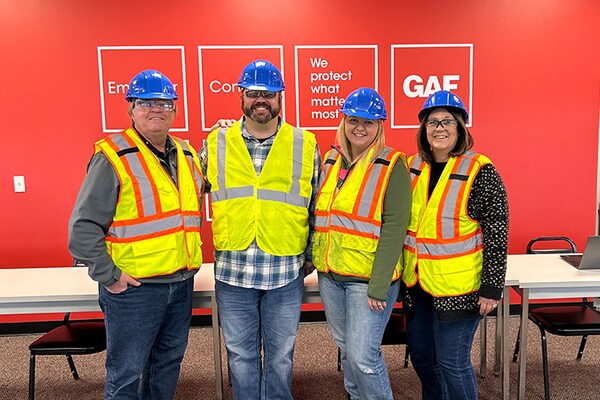 GAF employees in construction vests and hard hats