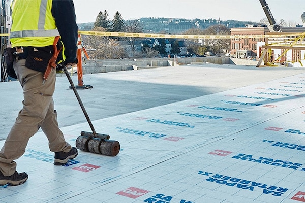 contractor rolling out GAF Vapor Retarder