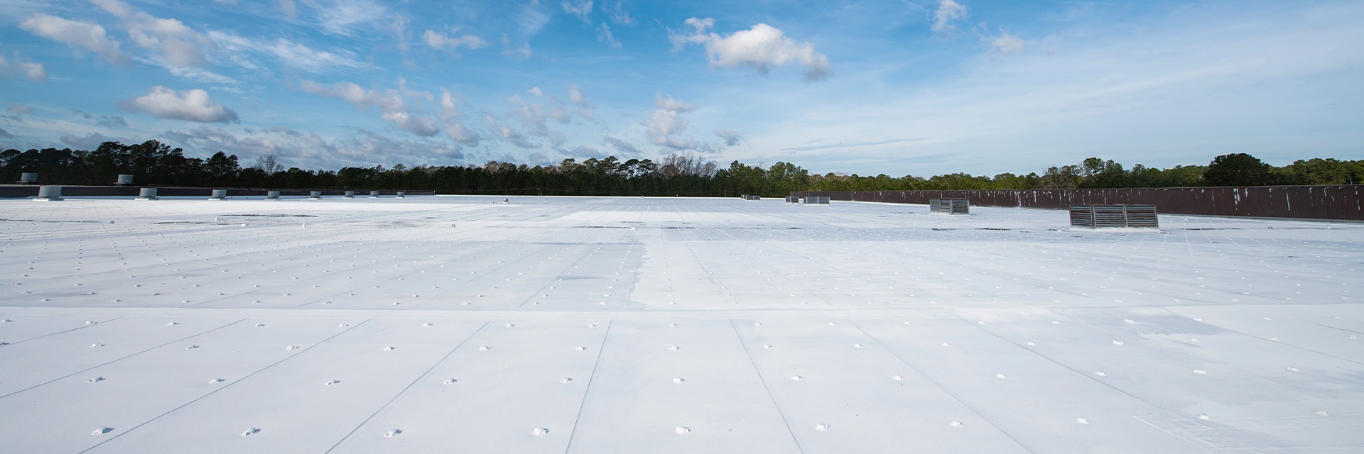 Building with a white, flat roof with GAF commercial roofing materials