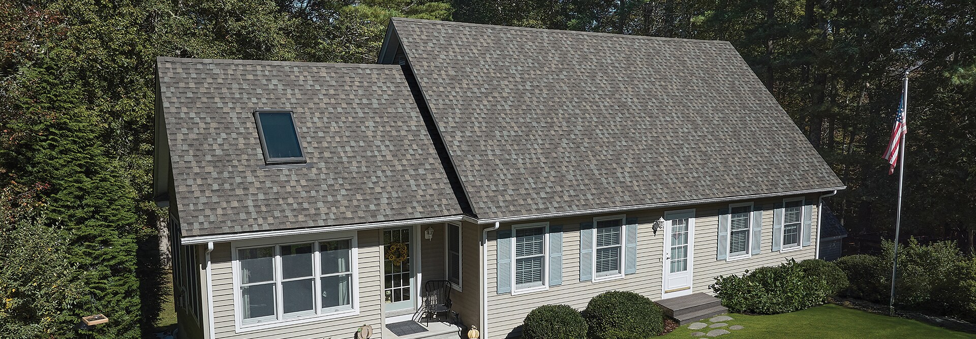 A residential house with a new gray asphalt roof built with Timberline HDZ Shingles.
